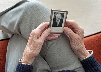 elderly-woman-holding-photo-of-a-man