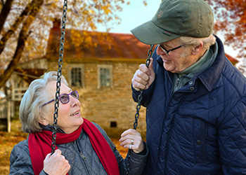 eldery-couple-talking-on-the-swing