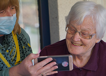 nurse-and-senior-woman-looking-at-phone